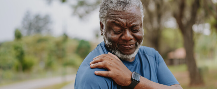 man holding shoulder in pain