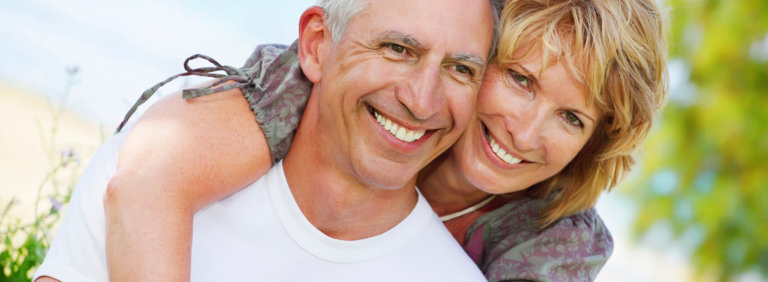 woman hugging mans back smiling