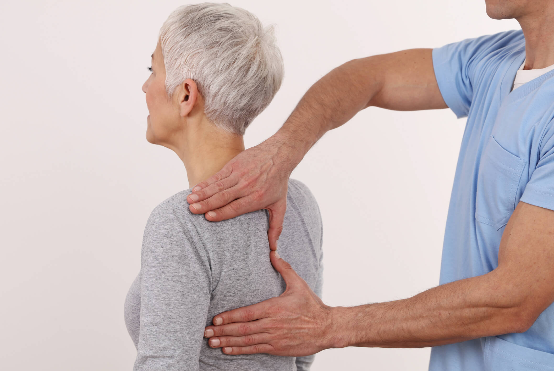 Older woman being checked by physiatrist