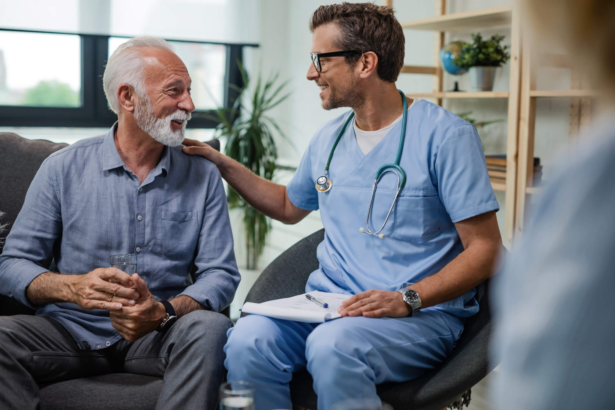 Older patient discussing integrative healthcare with his doctor.