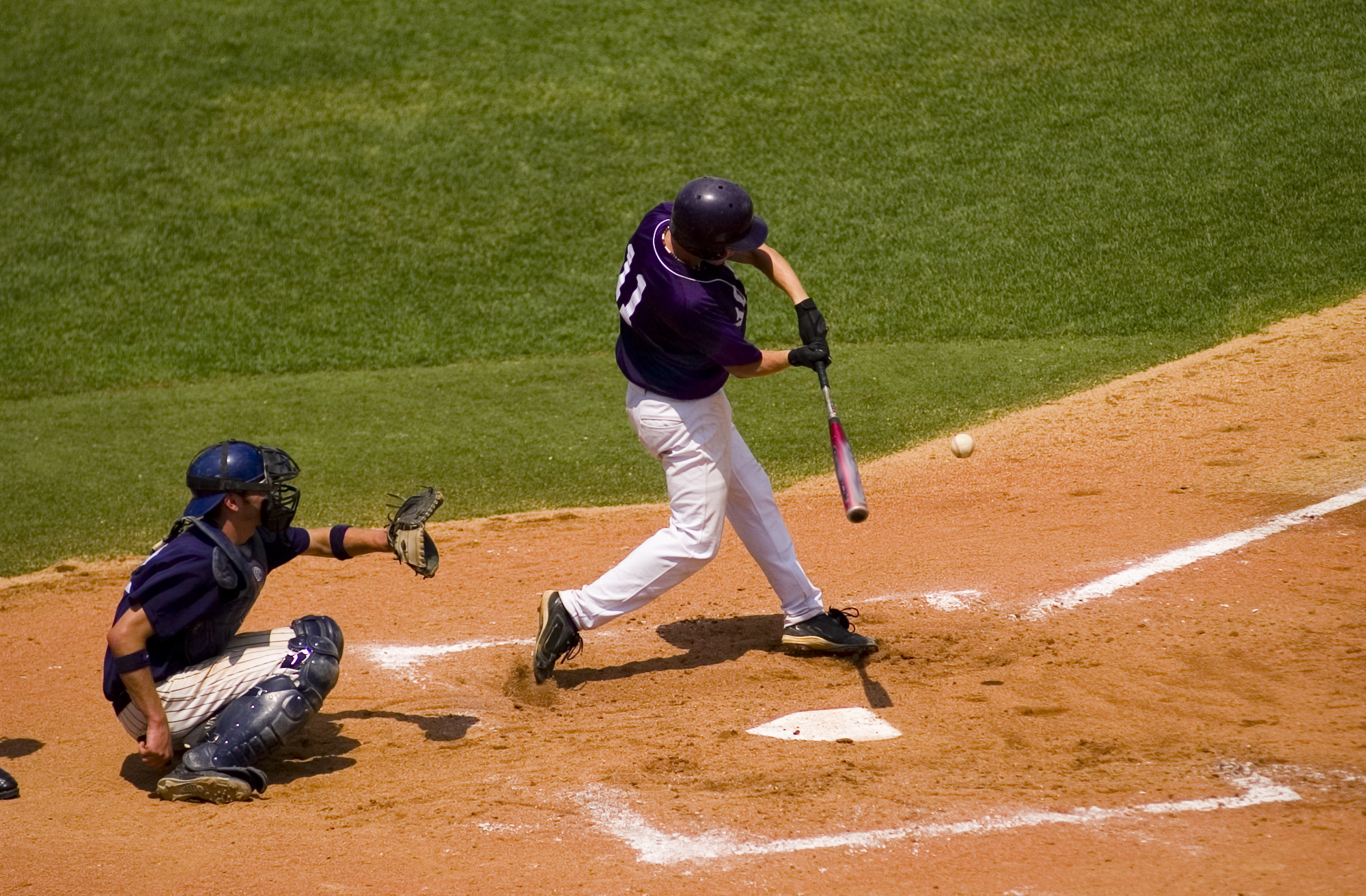 Baseball player taking a swing.