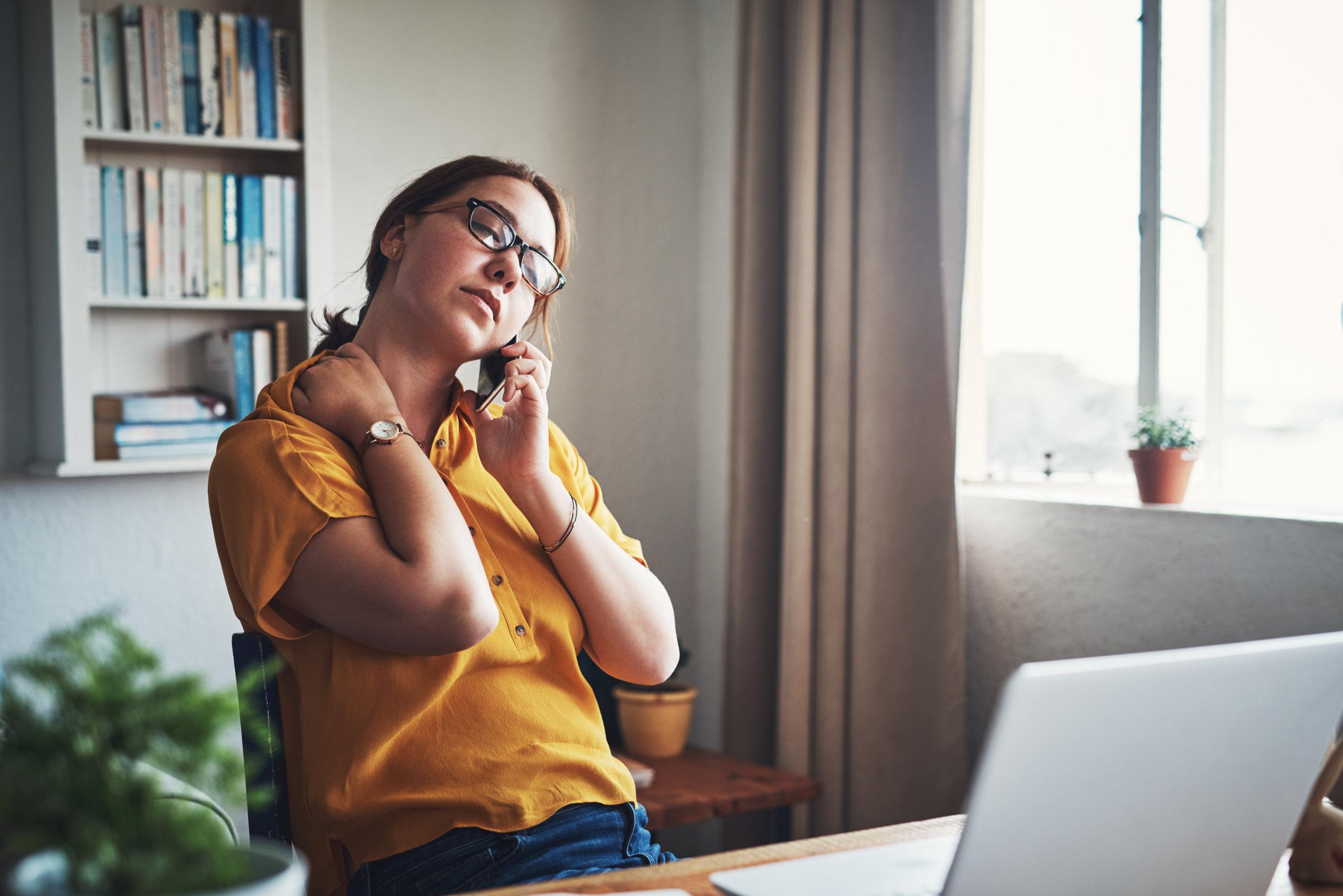 Woman with neck pain on the phone.