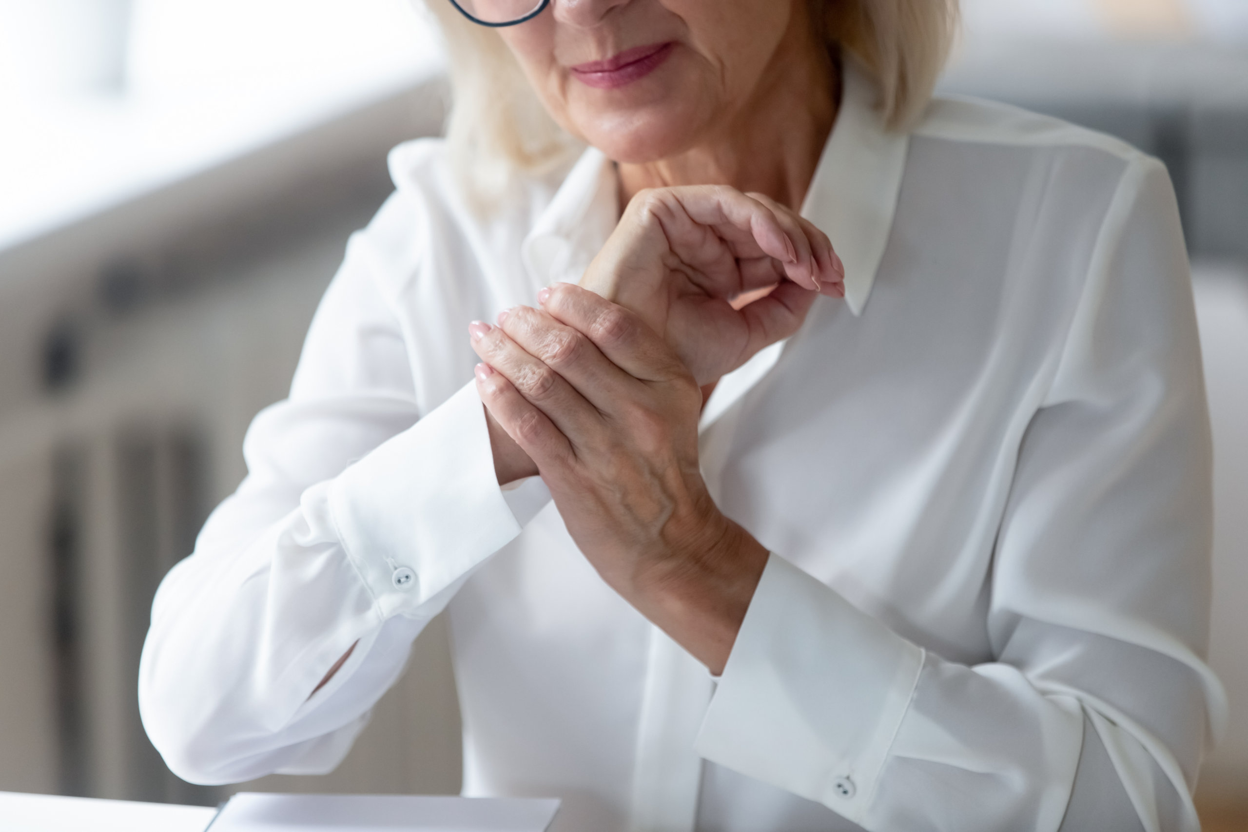 Older woman with a muscle pain in her wrist