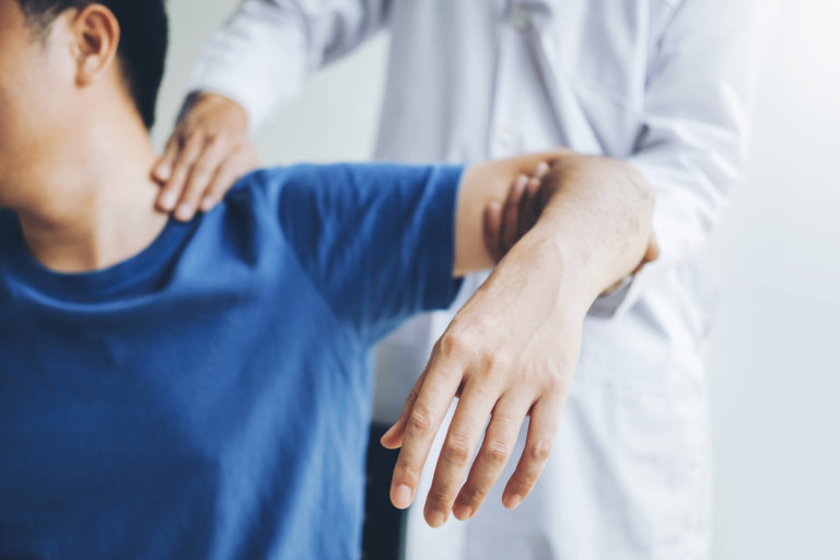 doctor checking shoulder pain