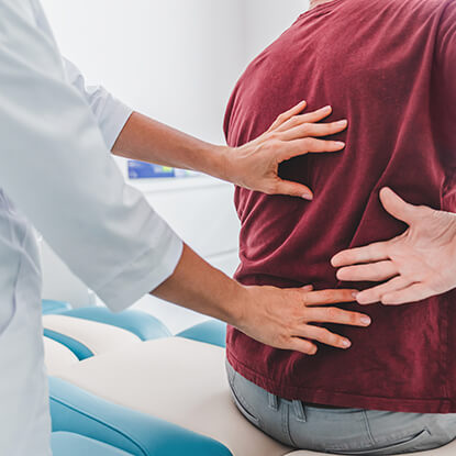 Doctor looking at patient's back