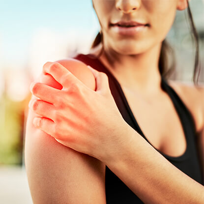 Woman clutching shoulder in pain