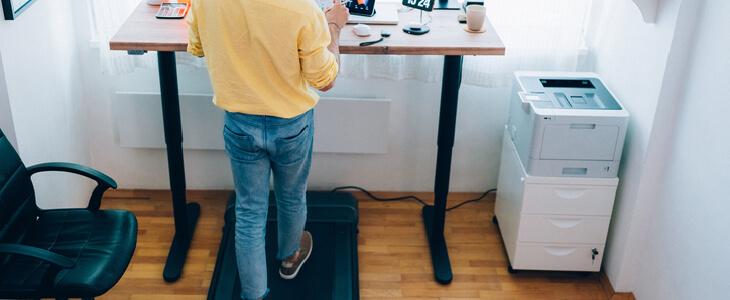 A man with an ergonomic standing desk