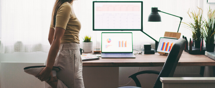 Woman doing exercises next to her work station