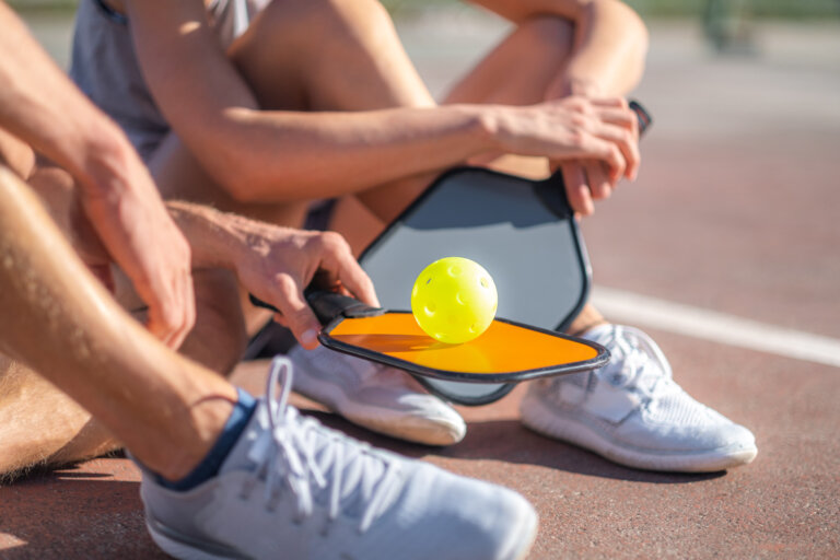 couple sitting down at pickleball court