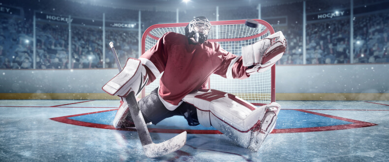 Hockey goalie trying to stop puck