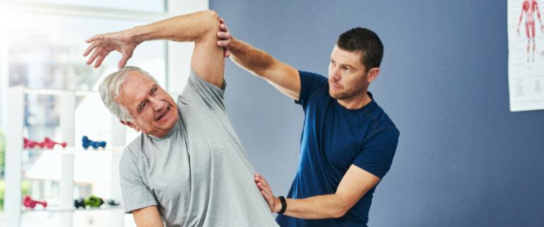 Physical therapist working with patient to improve range of motion