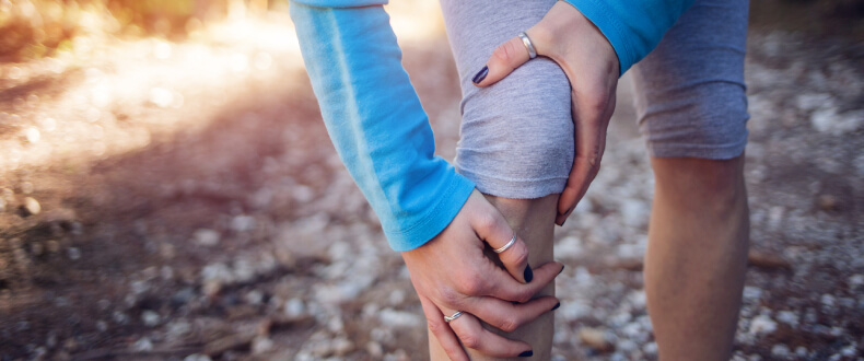 Woman holding knee in pain