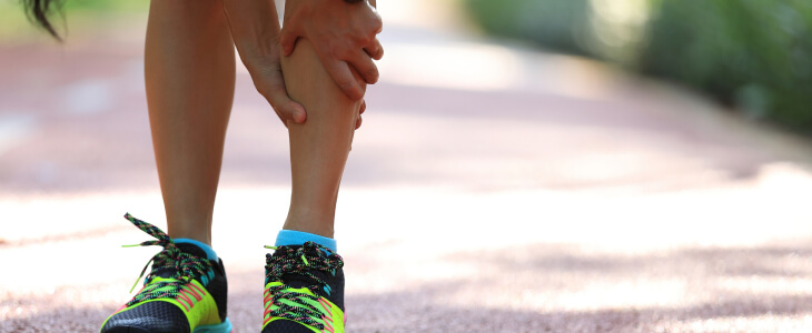 Person holding shin in pain due to spin splints