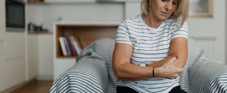 Mid adult woman having elbow pain