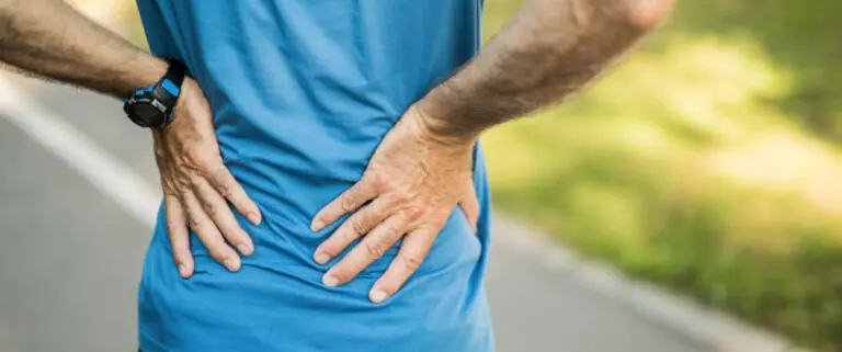 Man holding lower back with pain