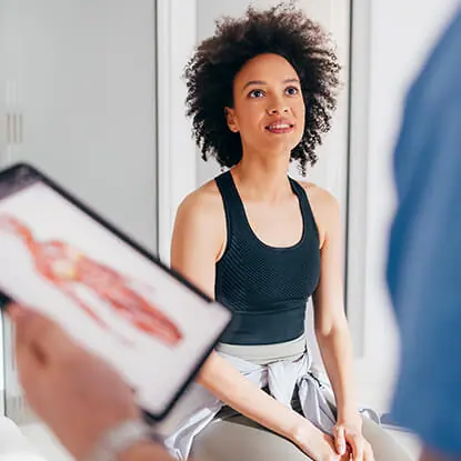 Woman in black top speaking to a doctor