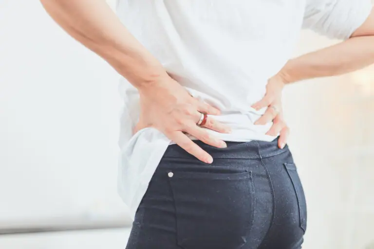 Woman holding low back in pain