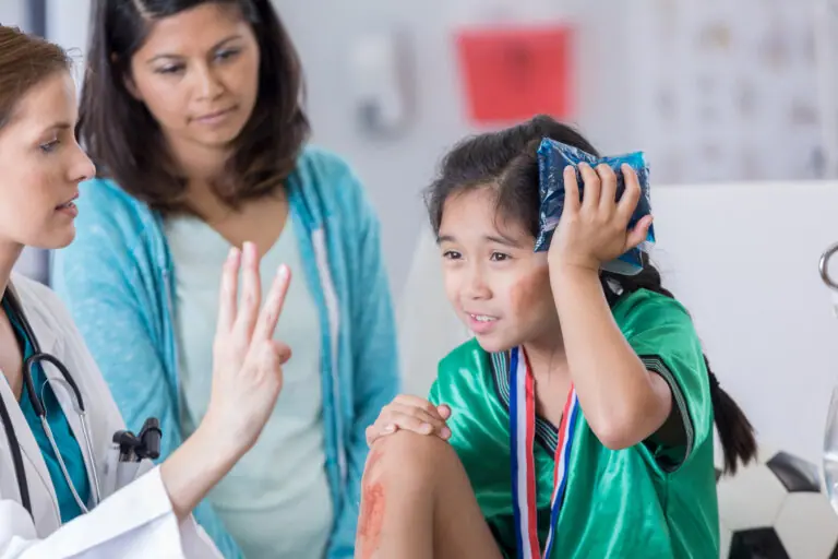 injured female elementary age soccer player.