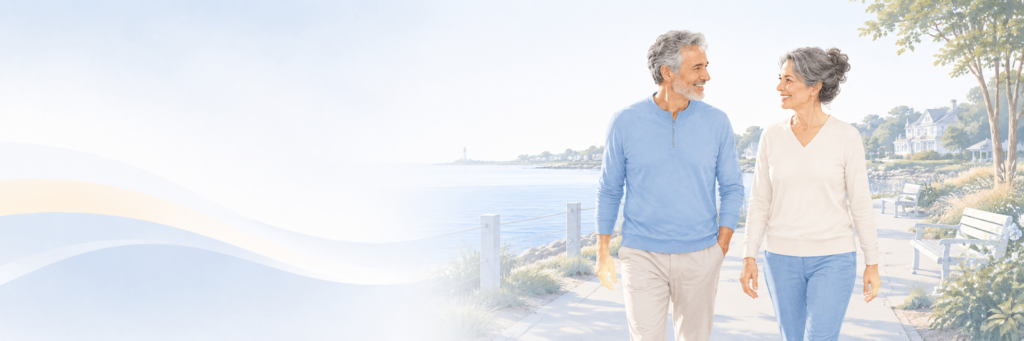 man and woman walking along the waterfront of long island 